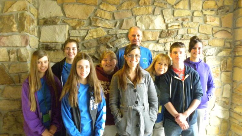 Students, 4-H Agent, 4-H Assistant and Volunteer pictured outside in front of a rock wall during Teen Summit 2014 a 